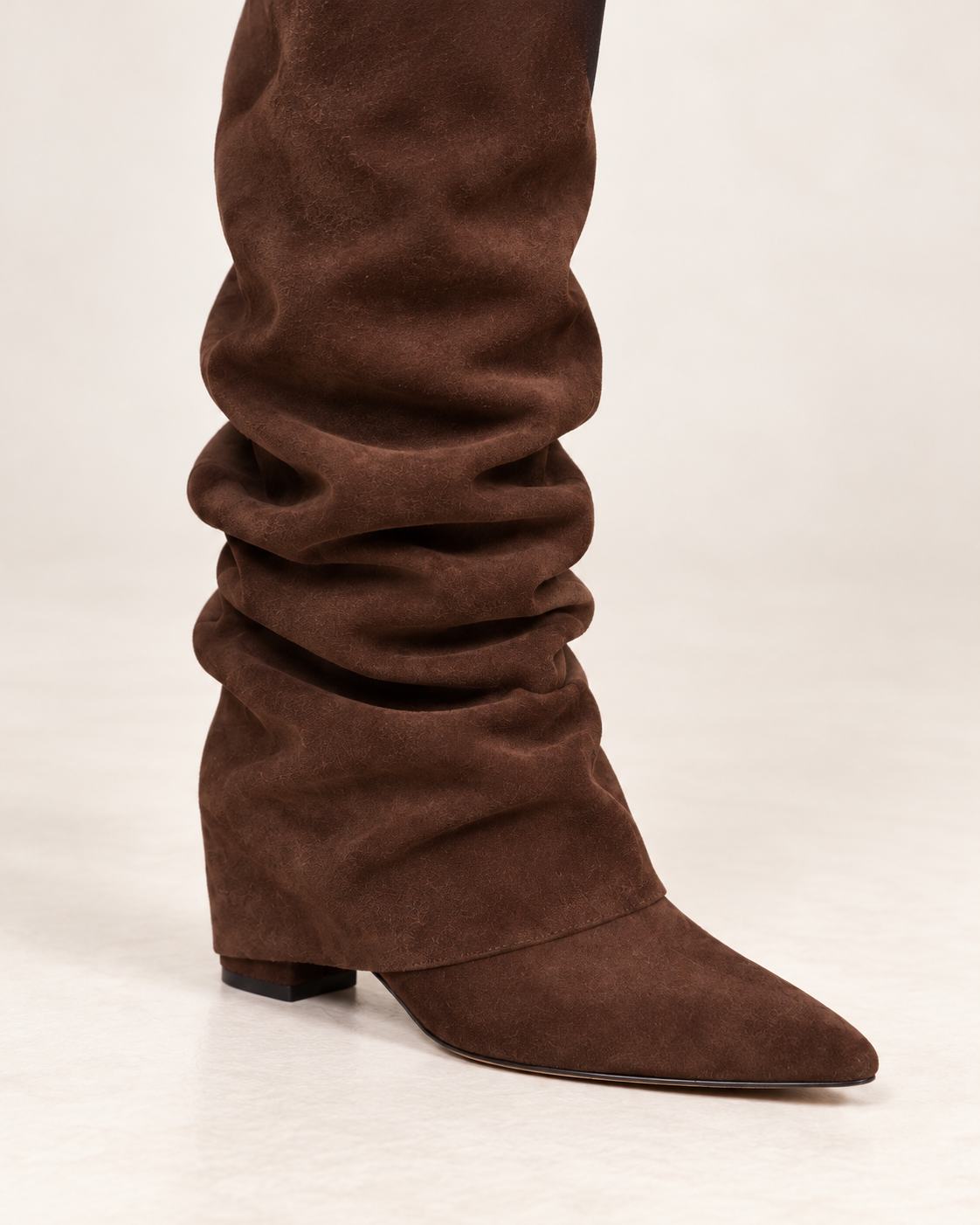 Women's dark brown suede slouch boot, close-up on foot