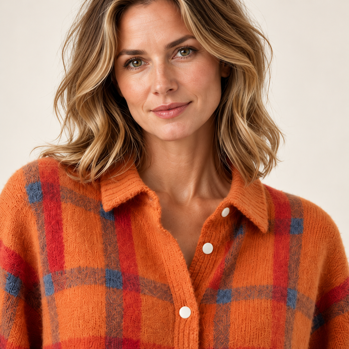 Orange check cardigan — chest-up on model