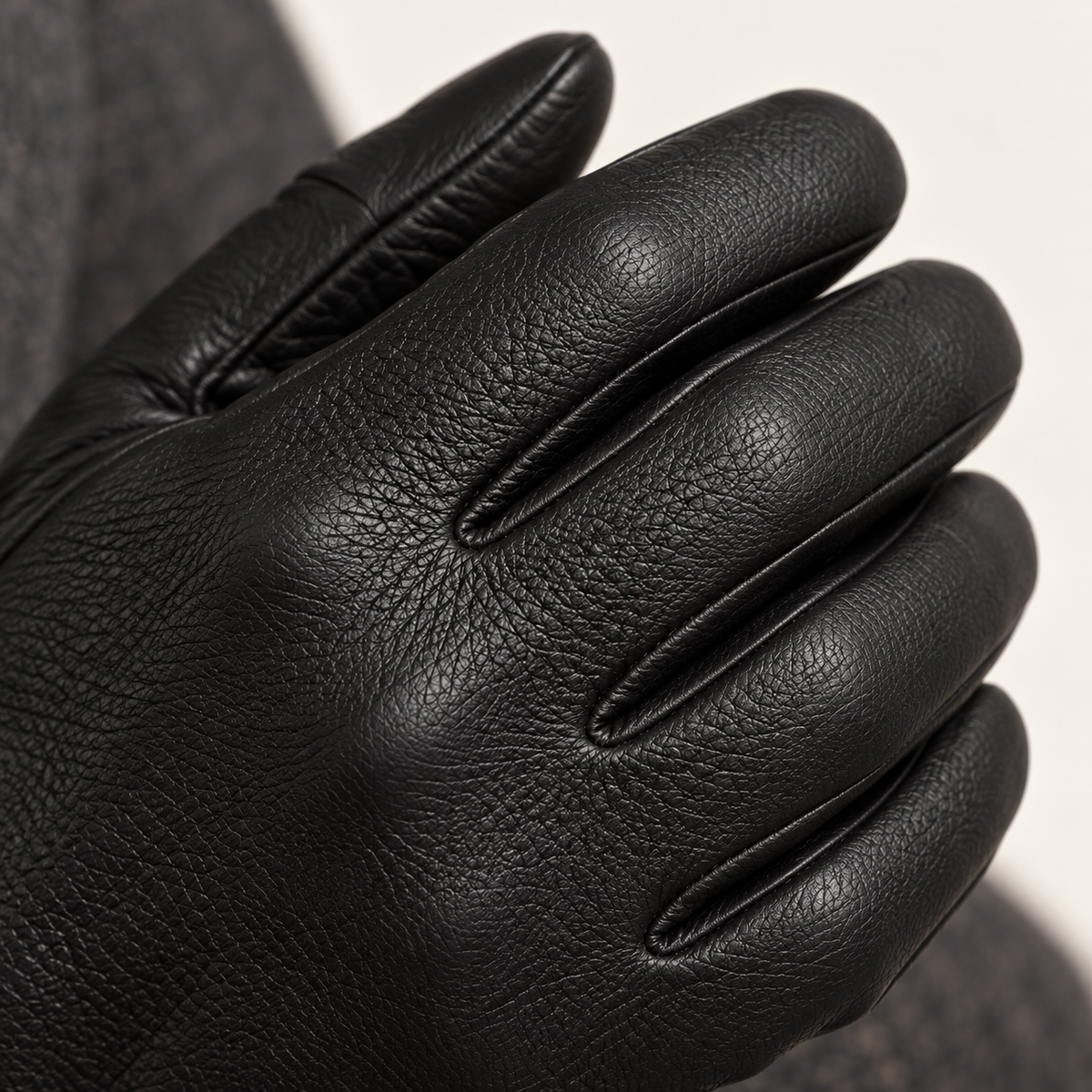 Black driving gloves — close-up on model