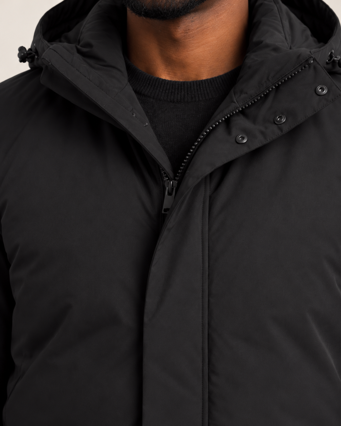 Men's hooded puffer jacket in black, walking view