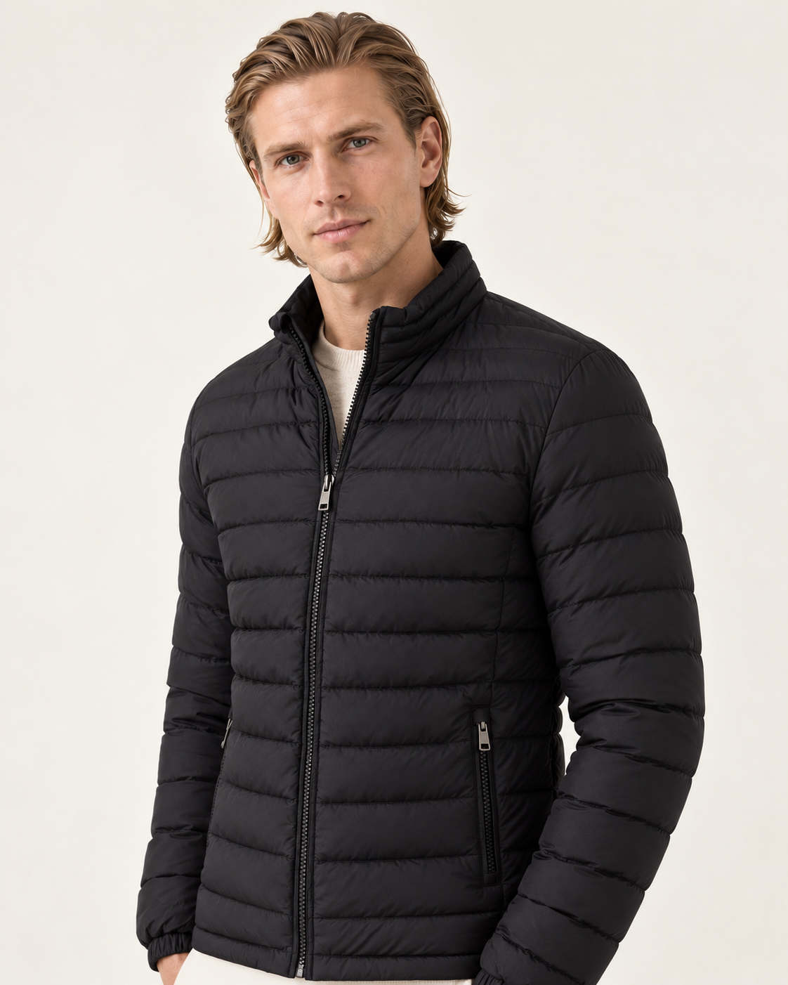 Men's lightweight puffer jacket in black, three-quarter view