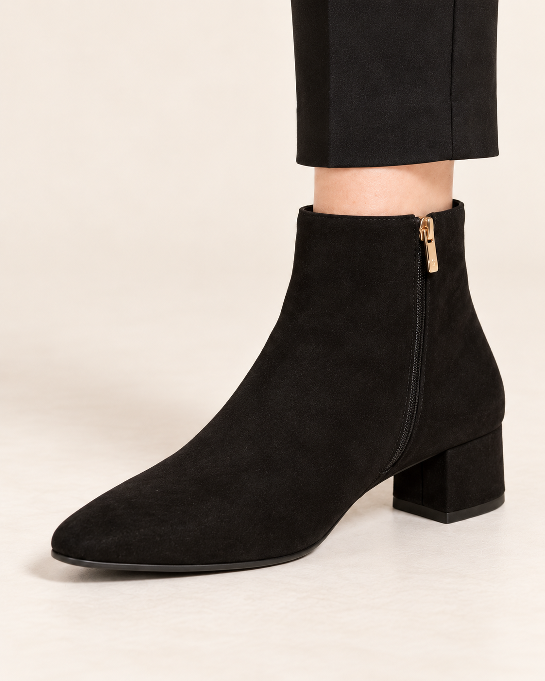 Women's black low heel ankle boots - close up worn