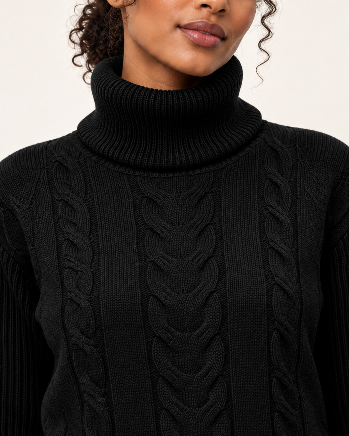 Women's cable knit jumper in black, roll neck close-up