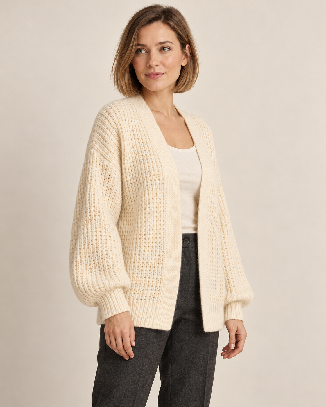 Women's chunky knit cardigan in white, three-quarter view