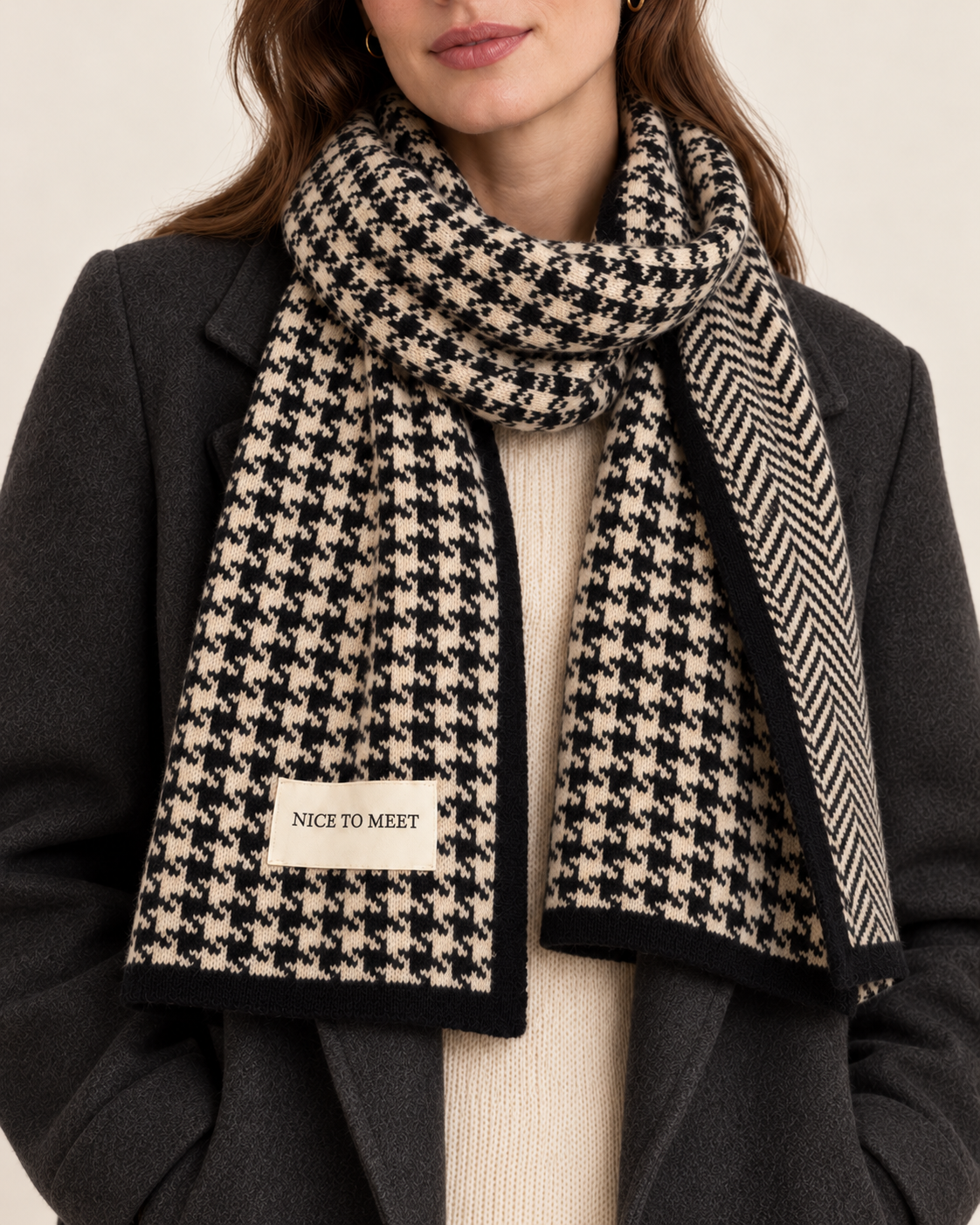 Women's black reversible houndstooth scarf - close up worn with sewn label