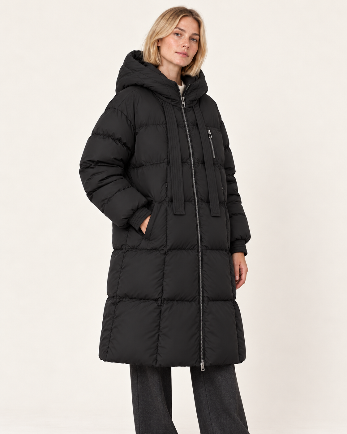 Women's long puffer coat in black, three-quarter view