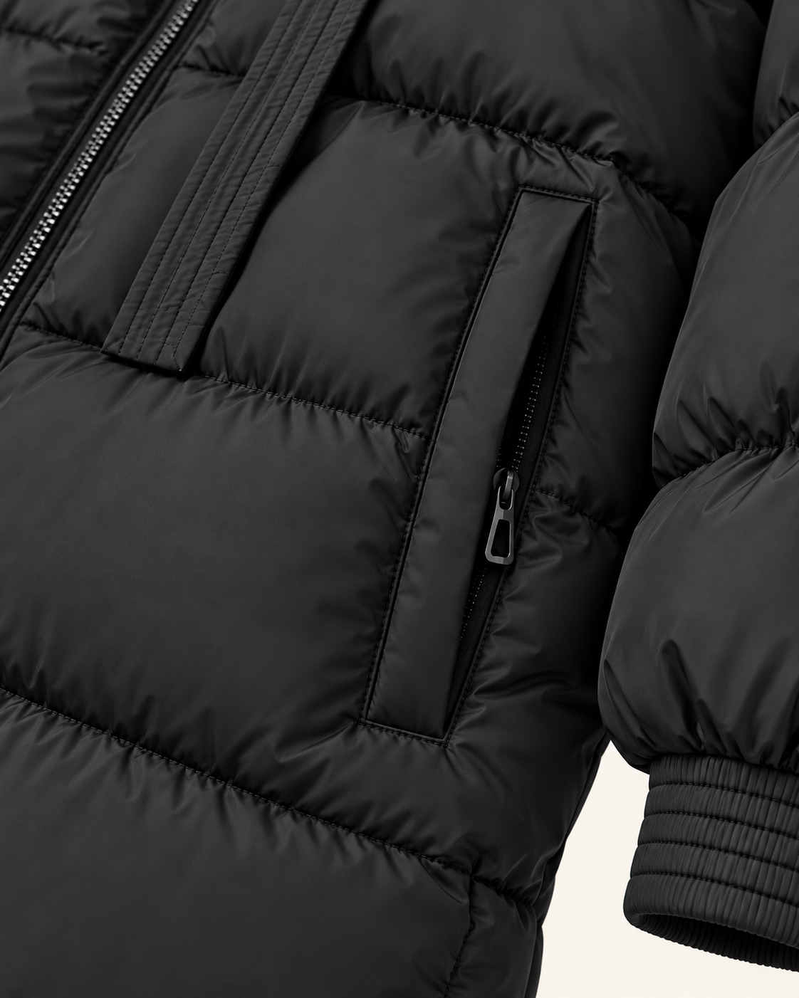 Women's long puffer coat in black, pocket and cuff detail