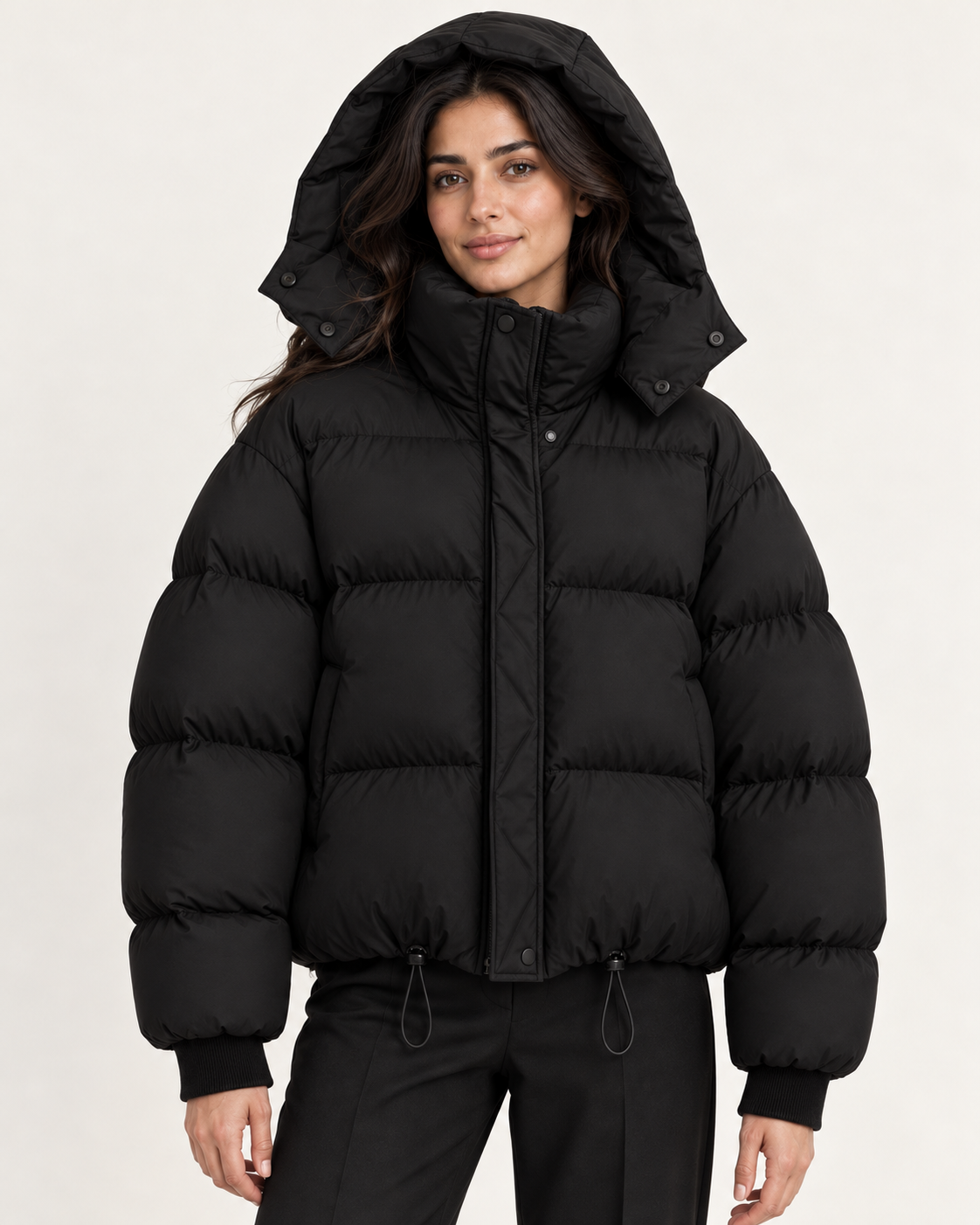 Women's puffer jacket in black, hood up view