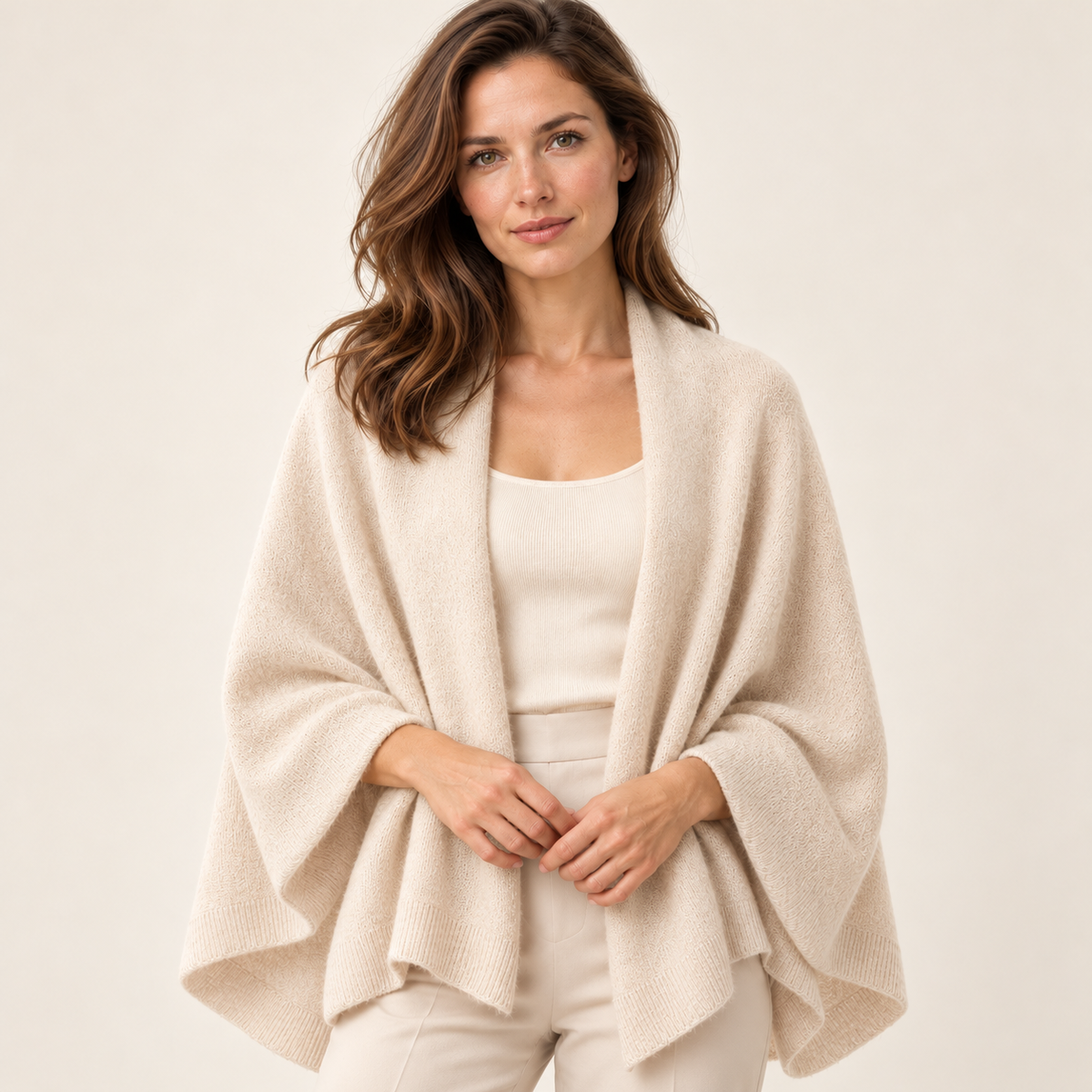 Beige scarf — Styling shot, same woman, pale beige wrap draped across shoulders over understated ivory top, relaxed hand resting lightly at waist